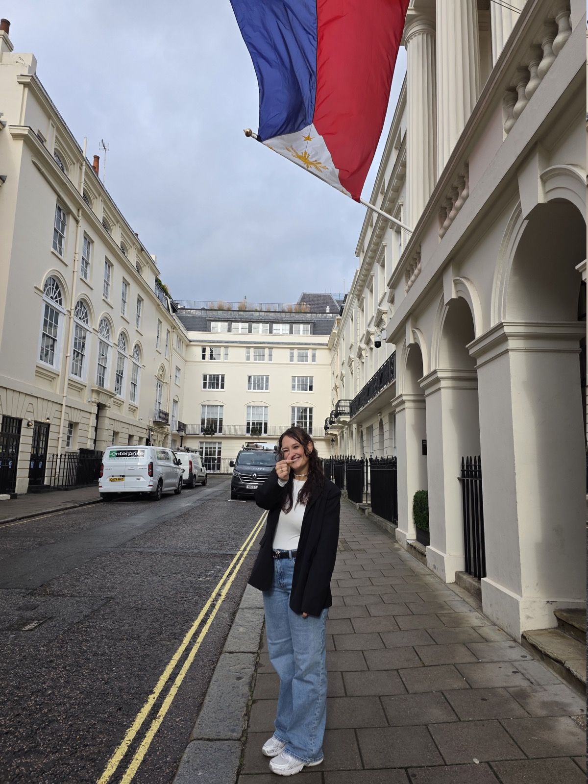 Vanessa in front of a Philippine flag